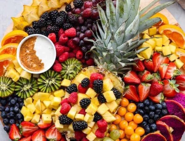Colorful fruit charcuterie board with pineapple.