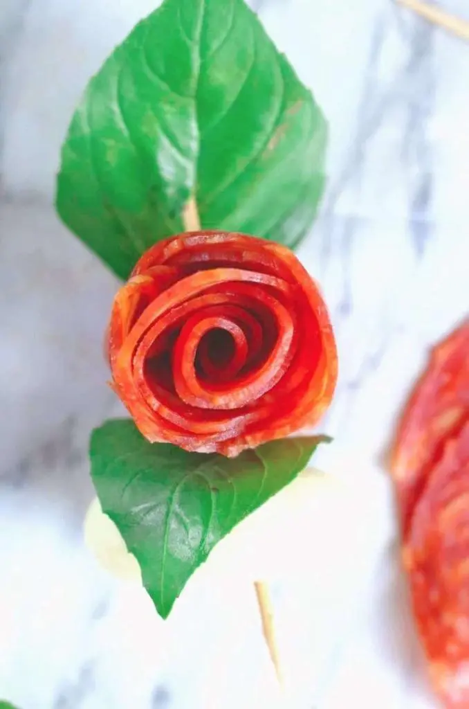 Salami rose flower with green leaves.