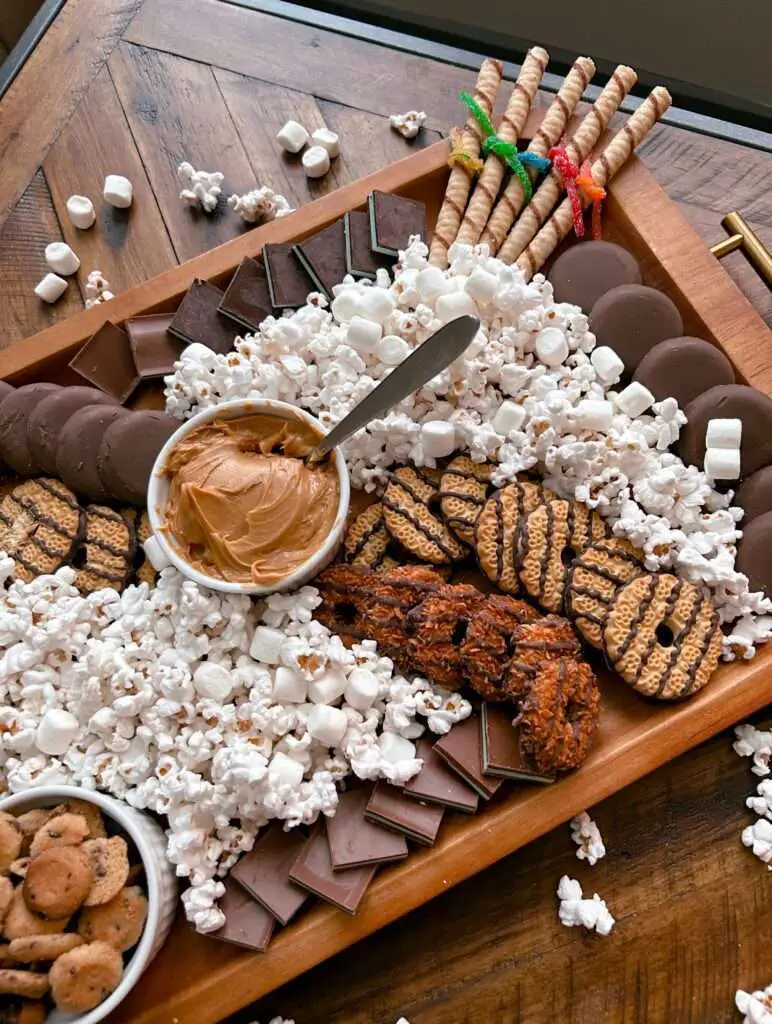 Popcorn and peanut butter on a board.