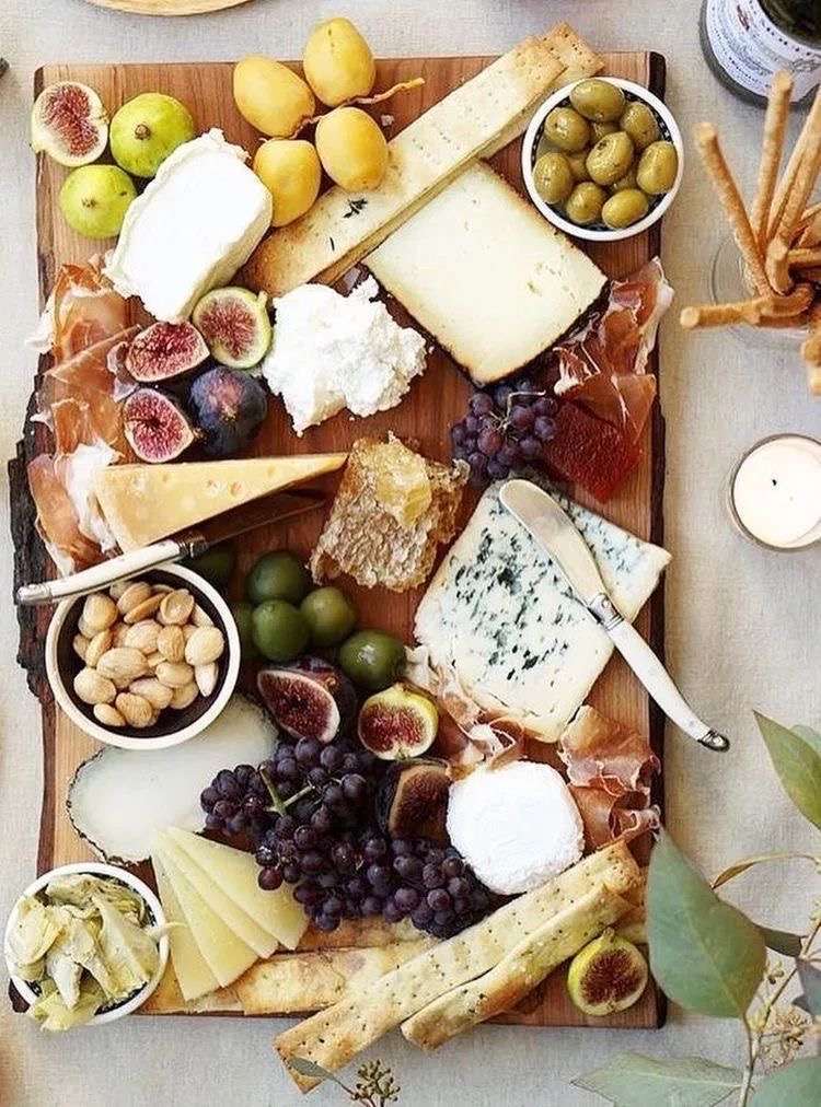 Charcuterie board with expensive cheeses and meats.